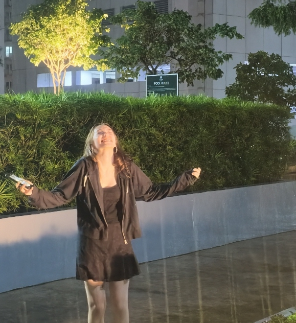 amy laughing outside in the rain at night