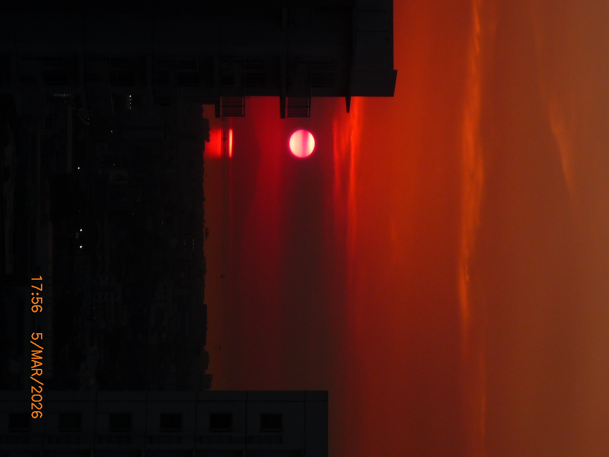 a red sunset with a film timestamp